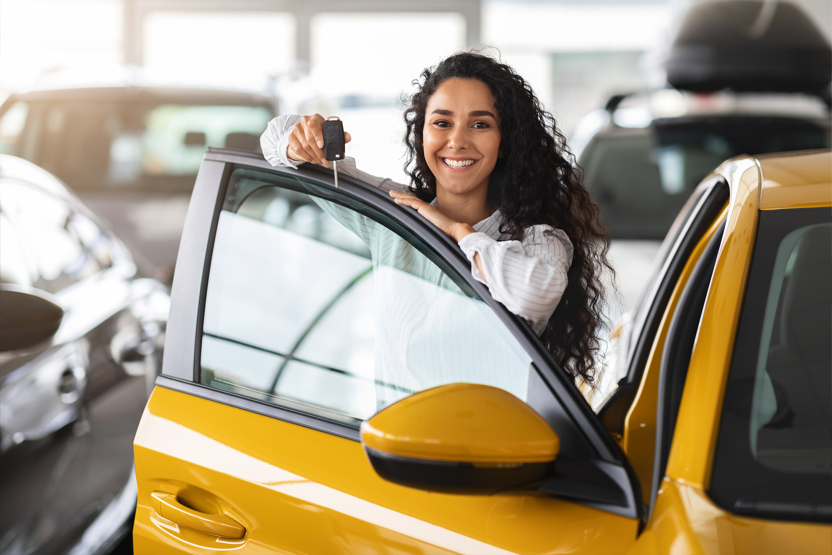 Woman with keys to a new car