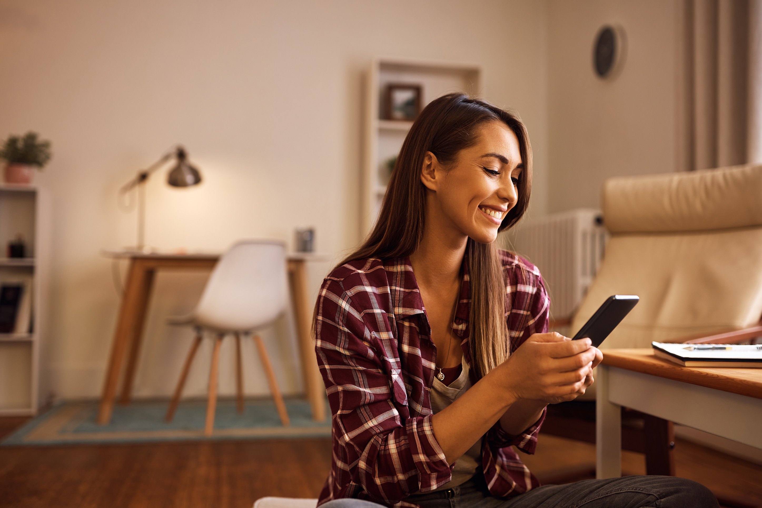 Woman paying her credit card on her mobile phone. 