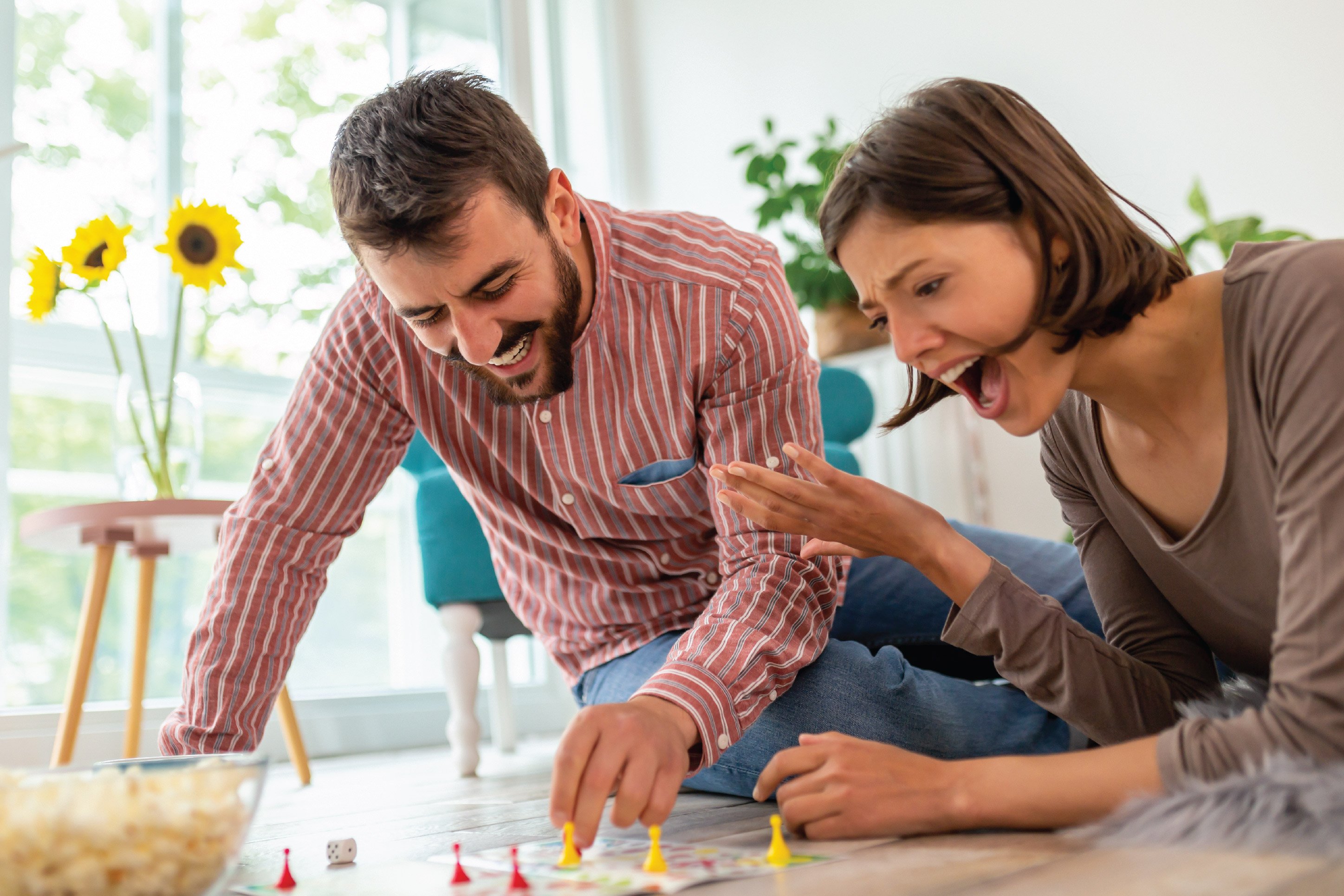 couple playing a board game together at home