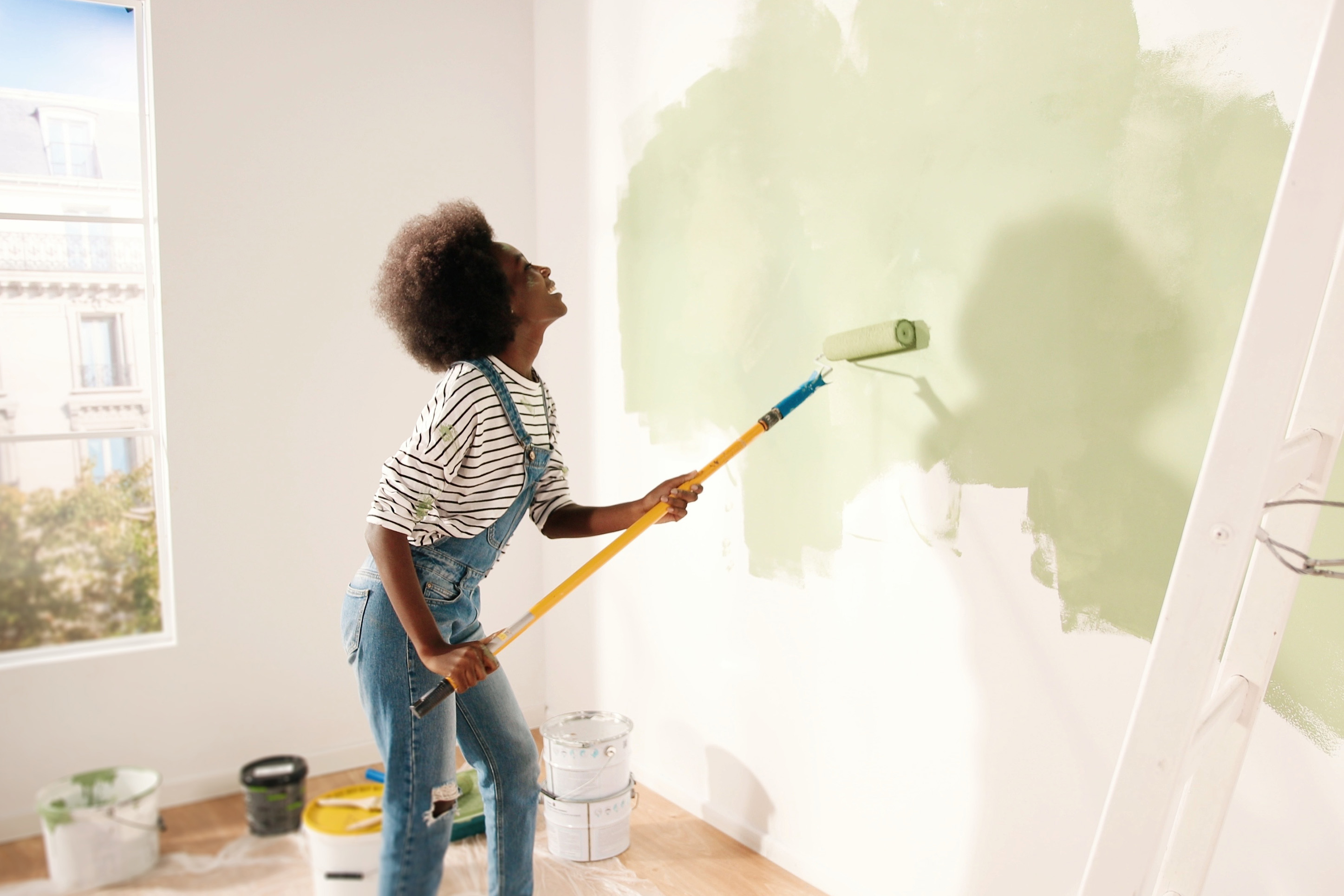 Woman painting a room in her home.