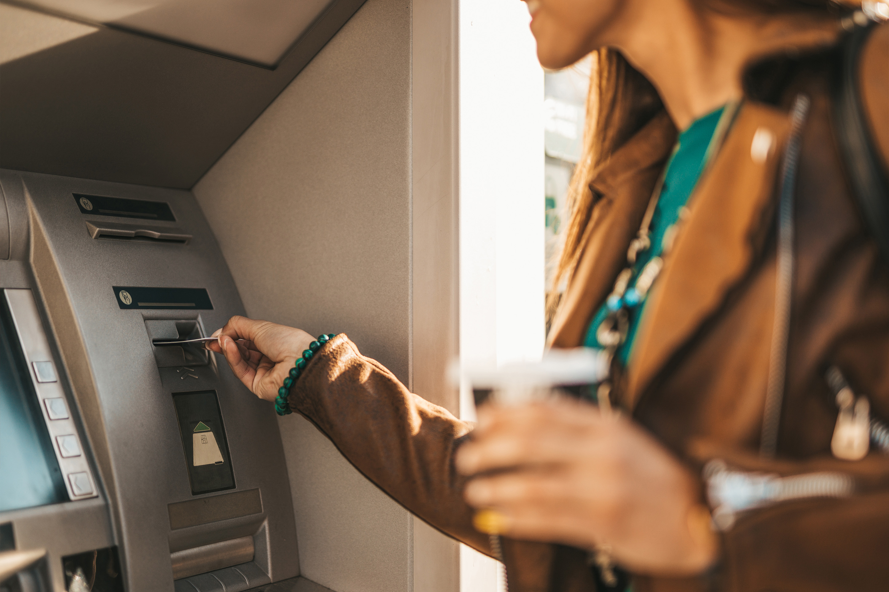 Woman getting cash out of an ATM