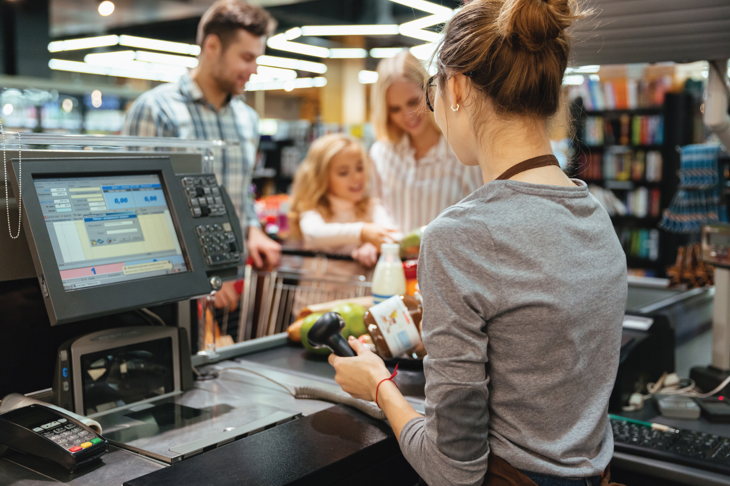 family buying groceries at the grocery store