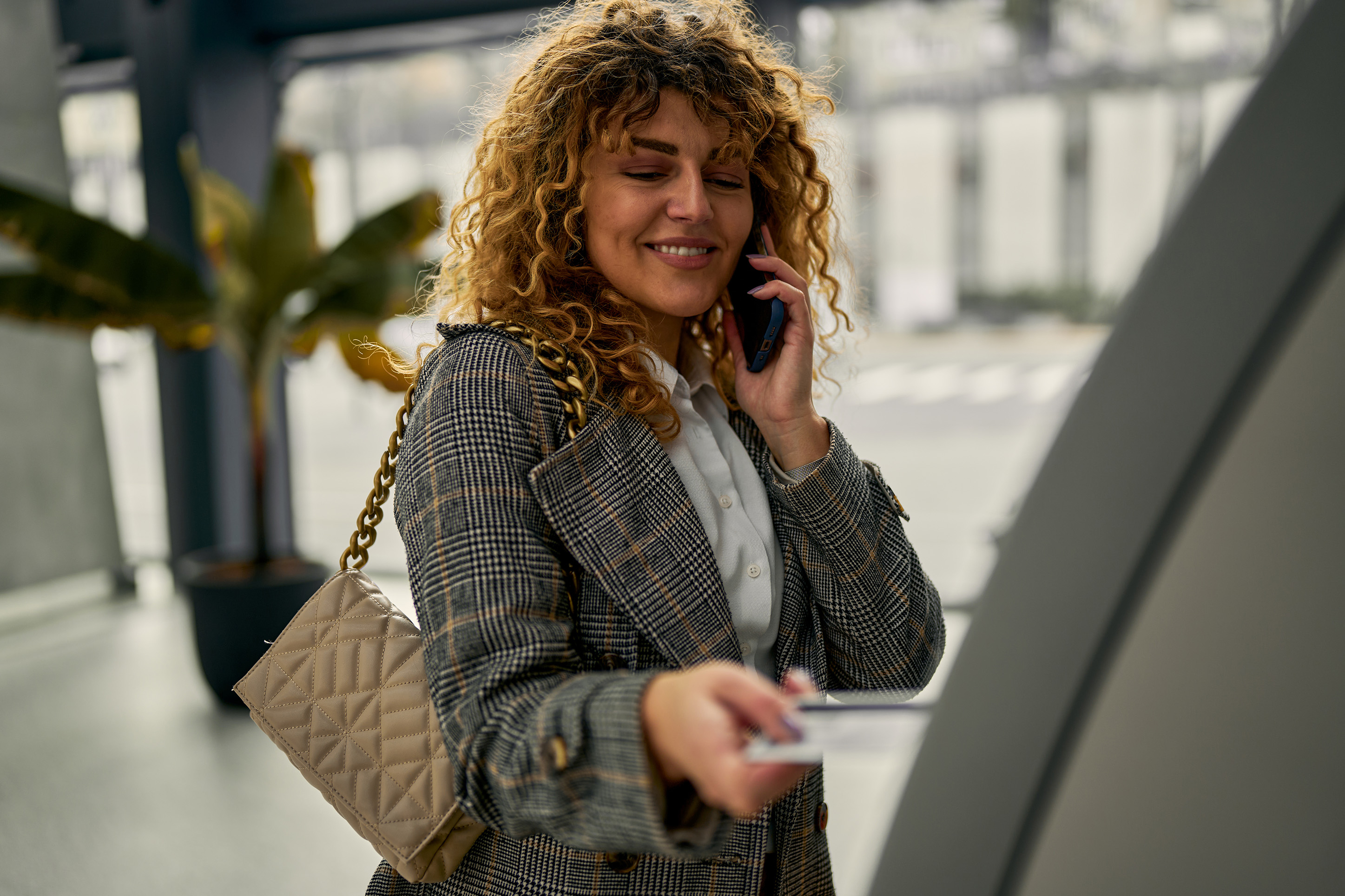 Woman on the phone making a purchase with credit card