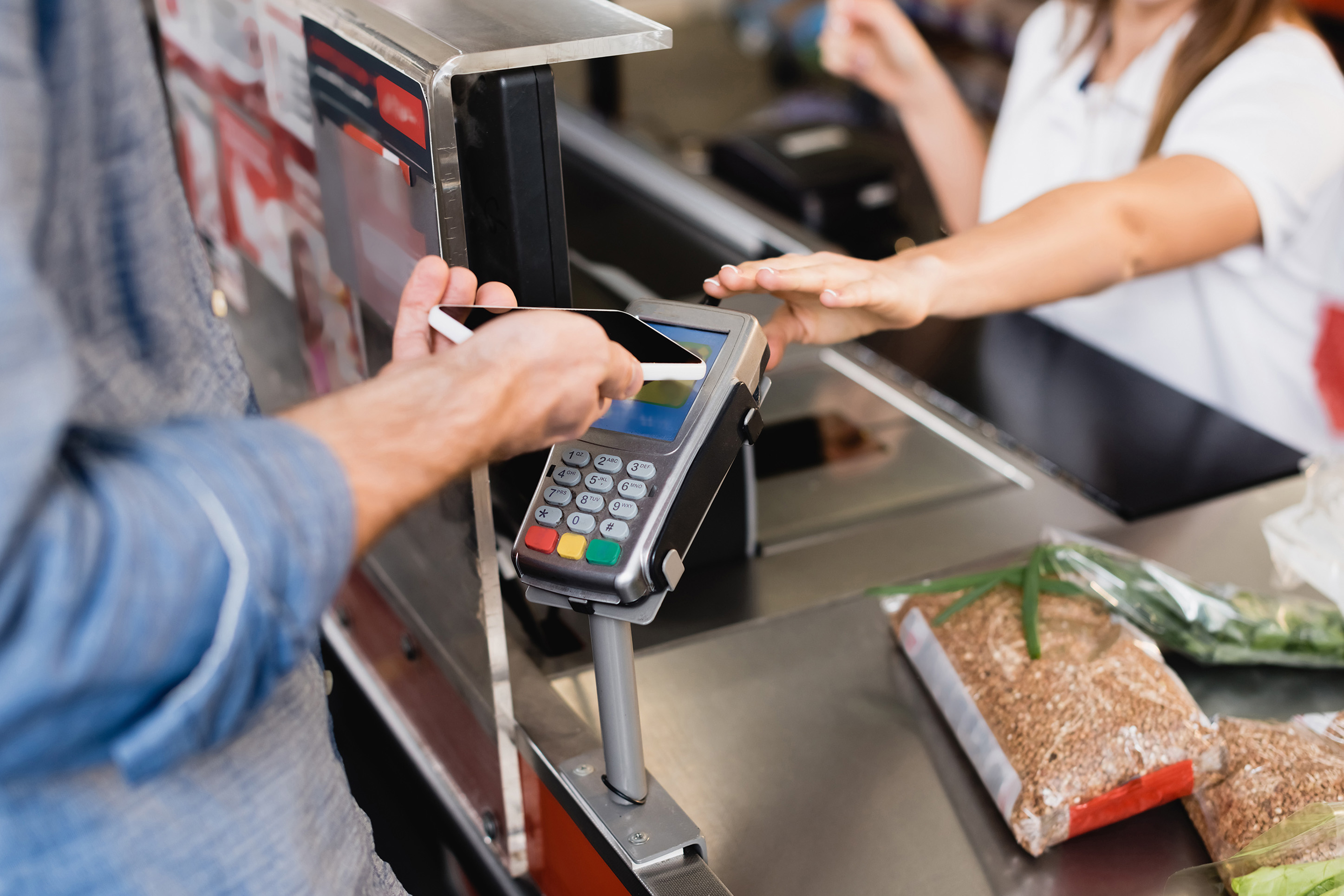 Someone purchasing groceries with a credit card