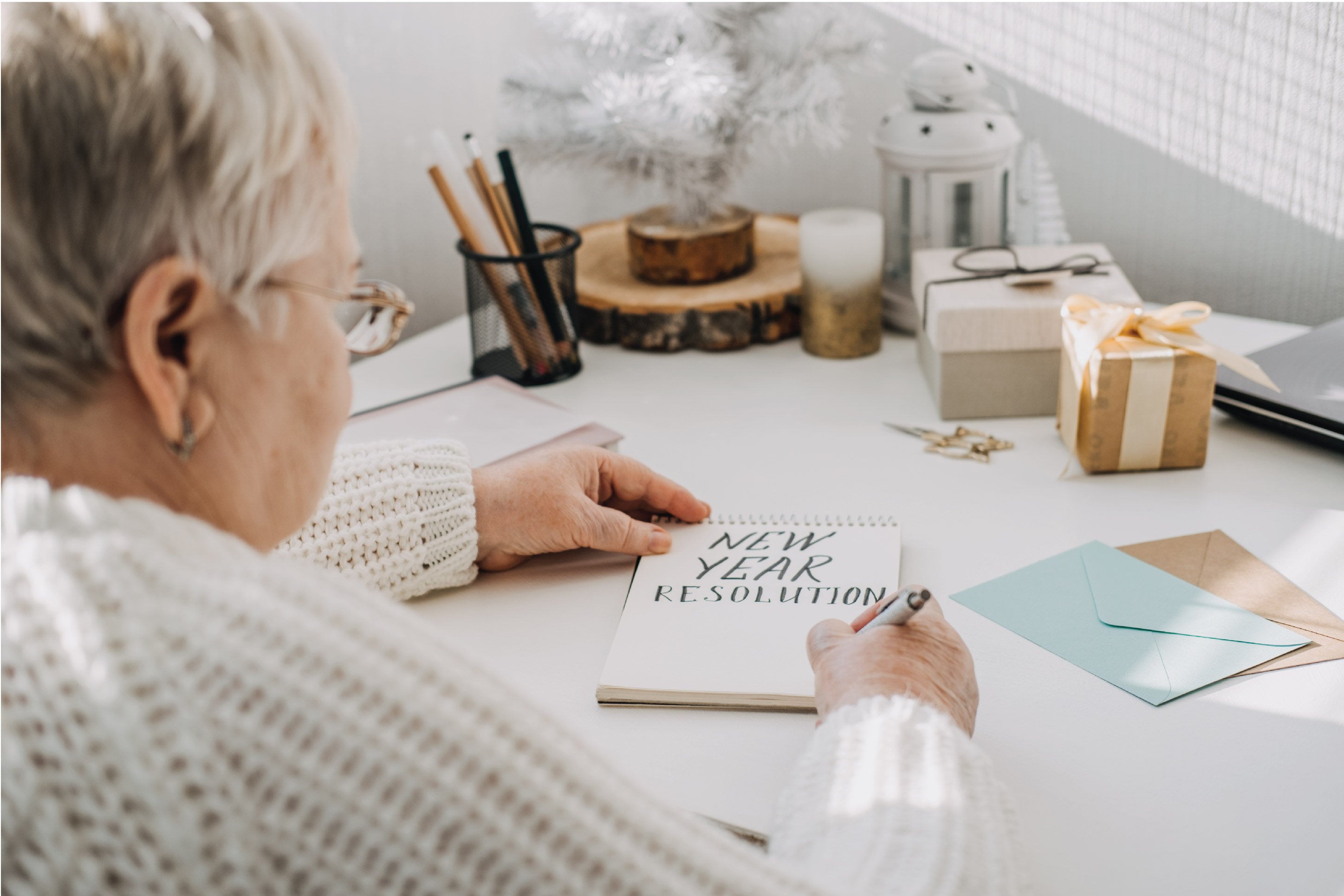 woman writing her New Year's resolution