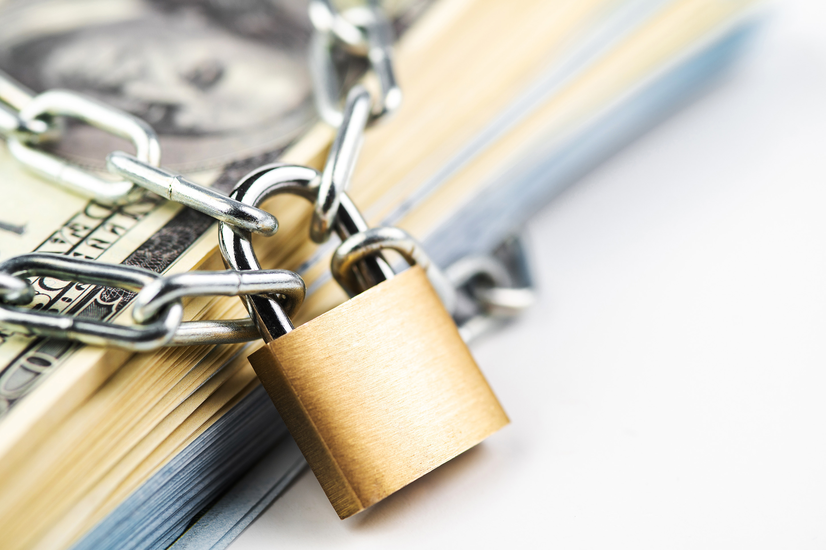 Image of money under a lock and chain. 