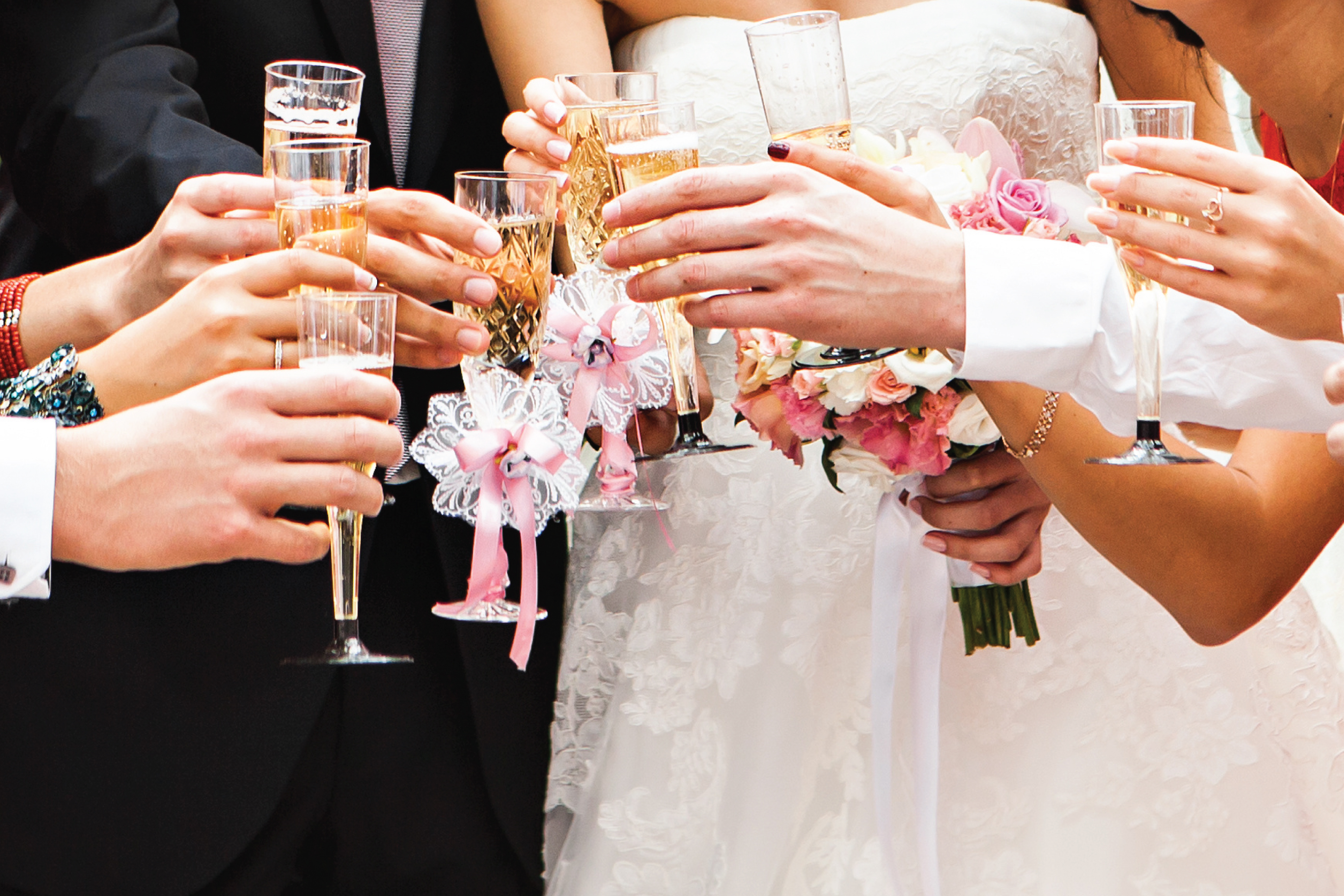 bride, groom and wedding party toasting with champagne