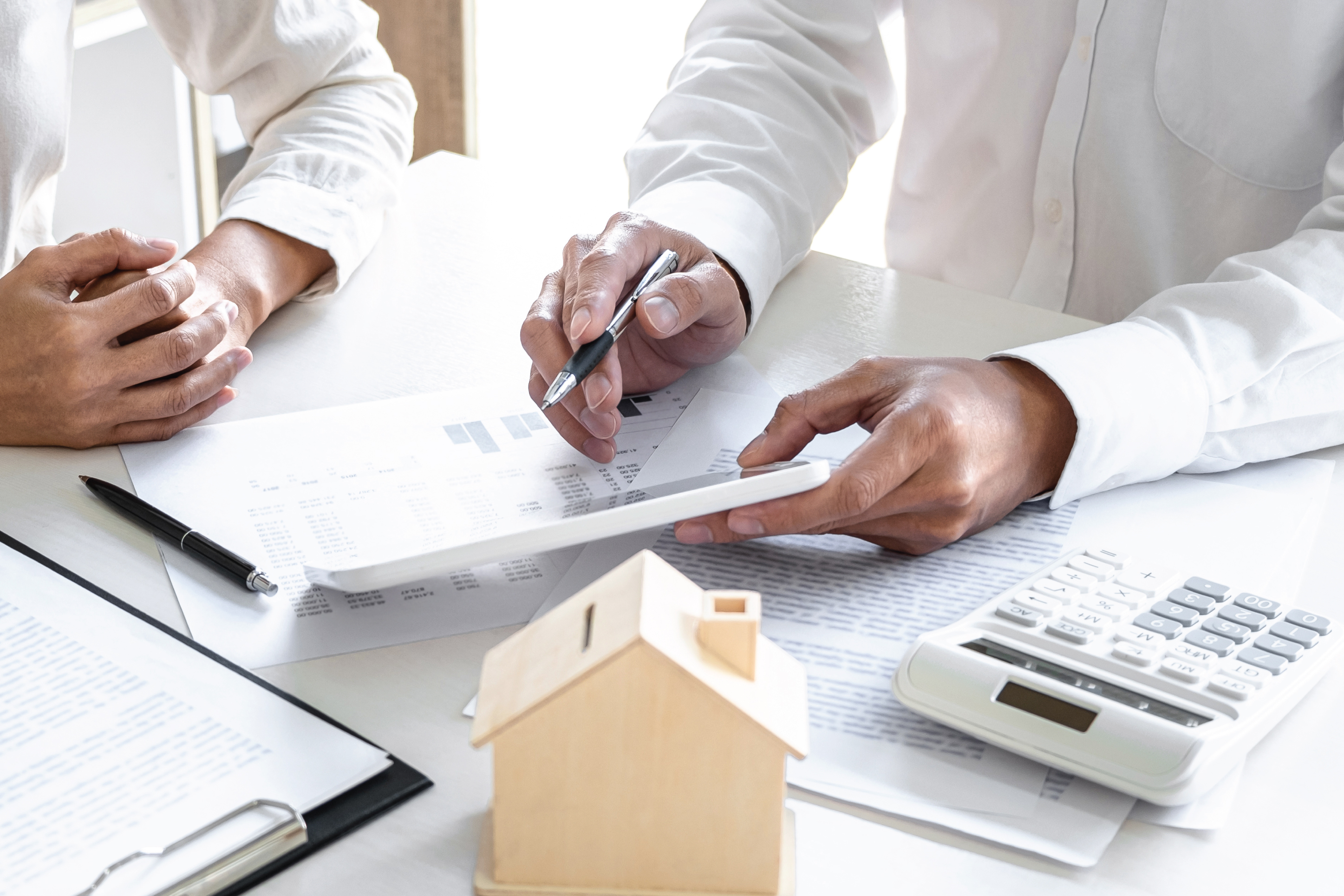 man pointing to homebuying documents