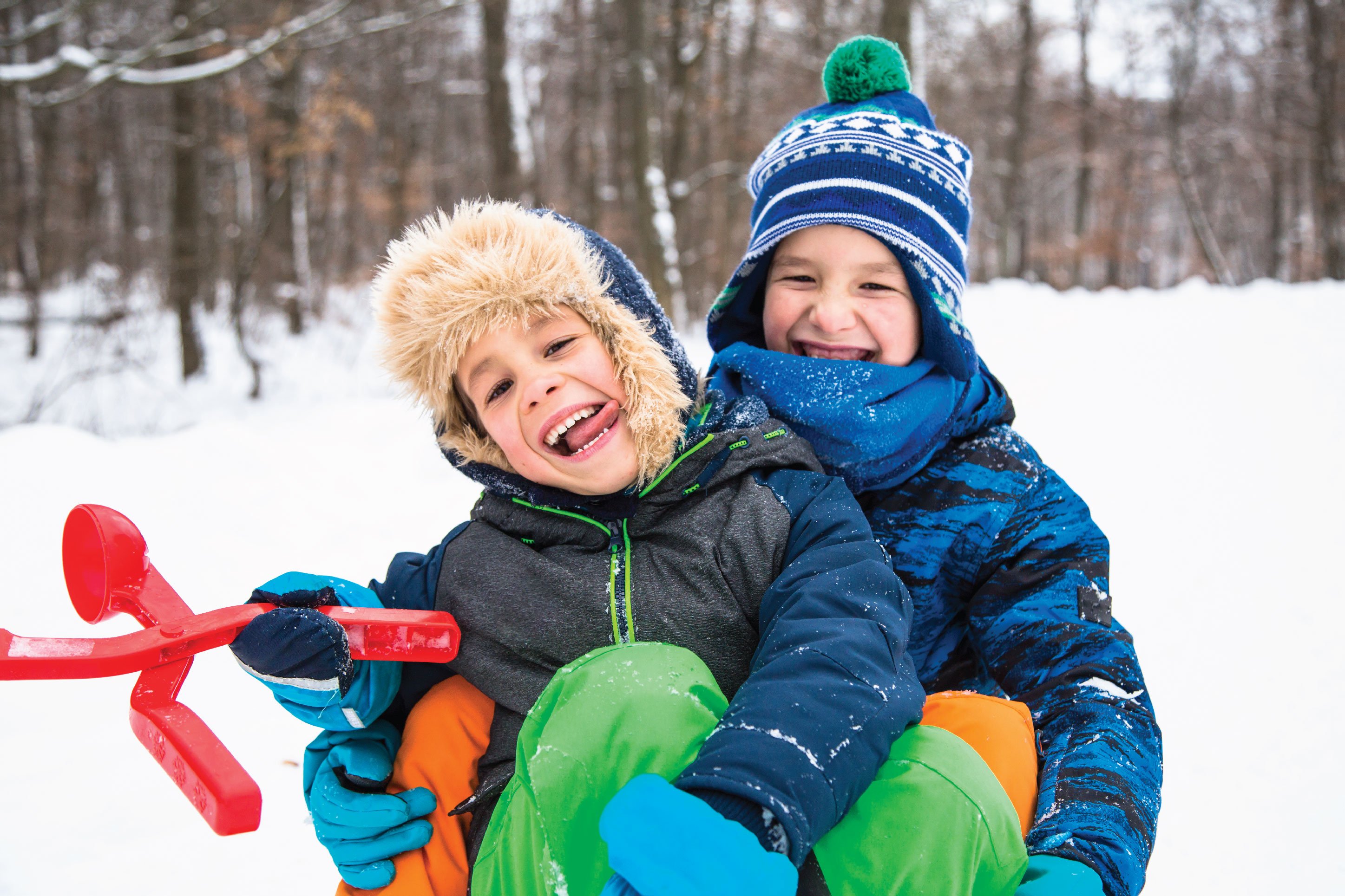 two kids playing in the snow