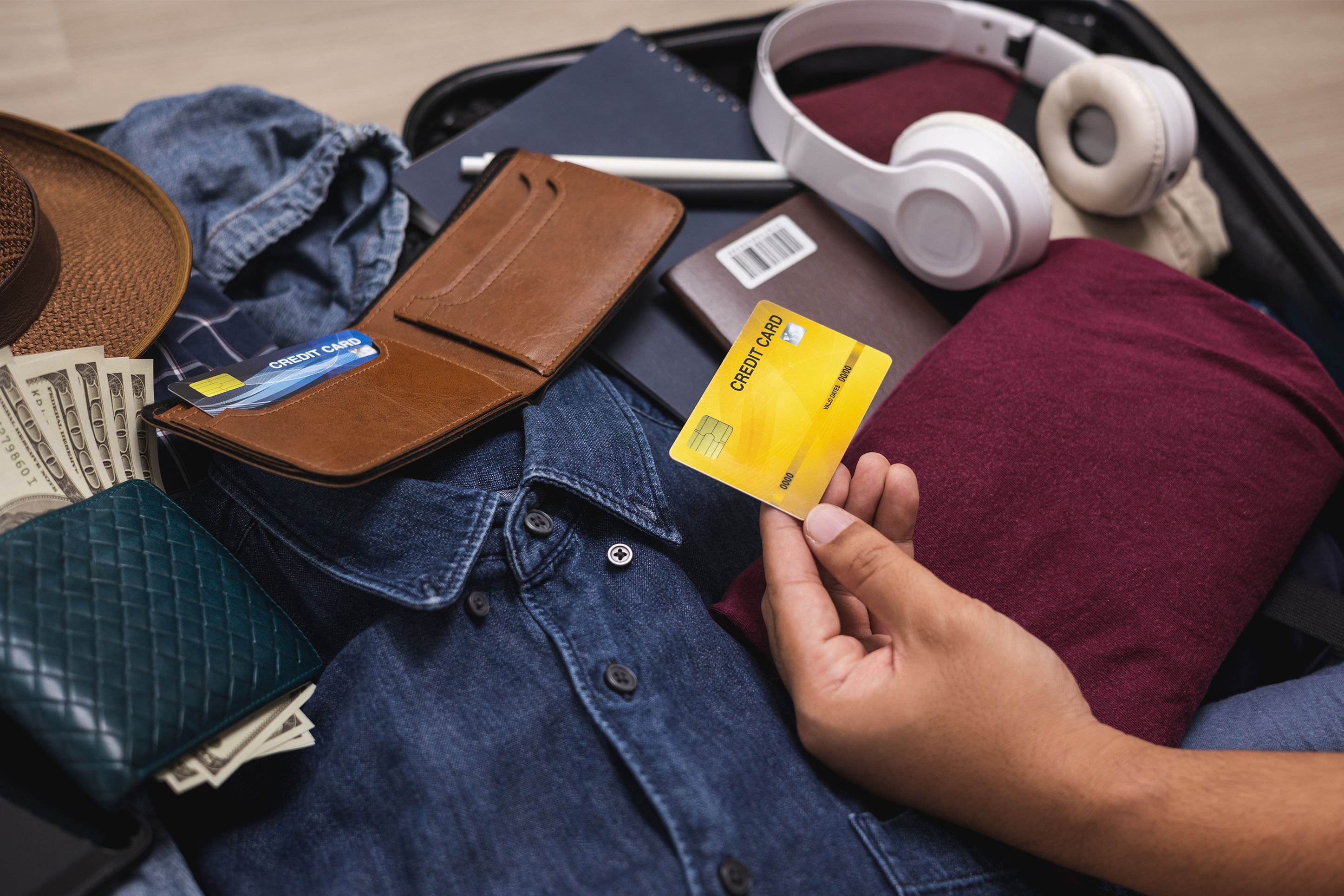 Packing for vacation, including a credit card with rewards. 