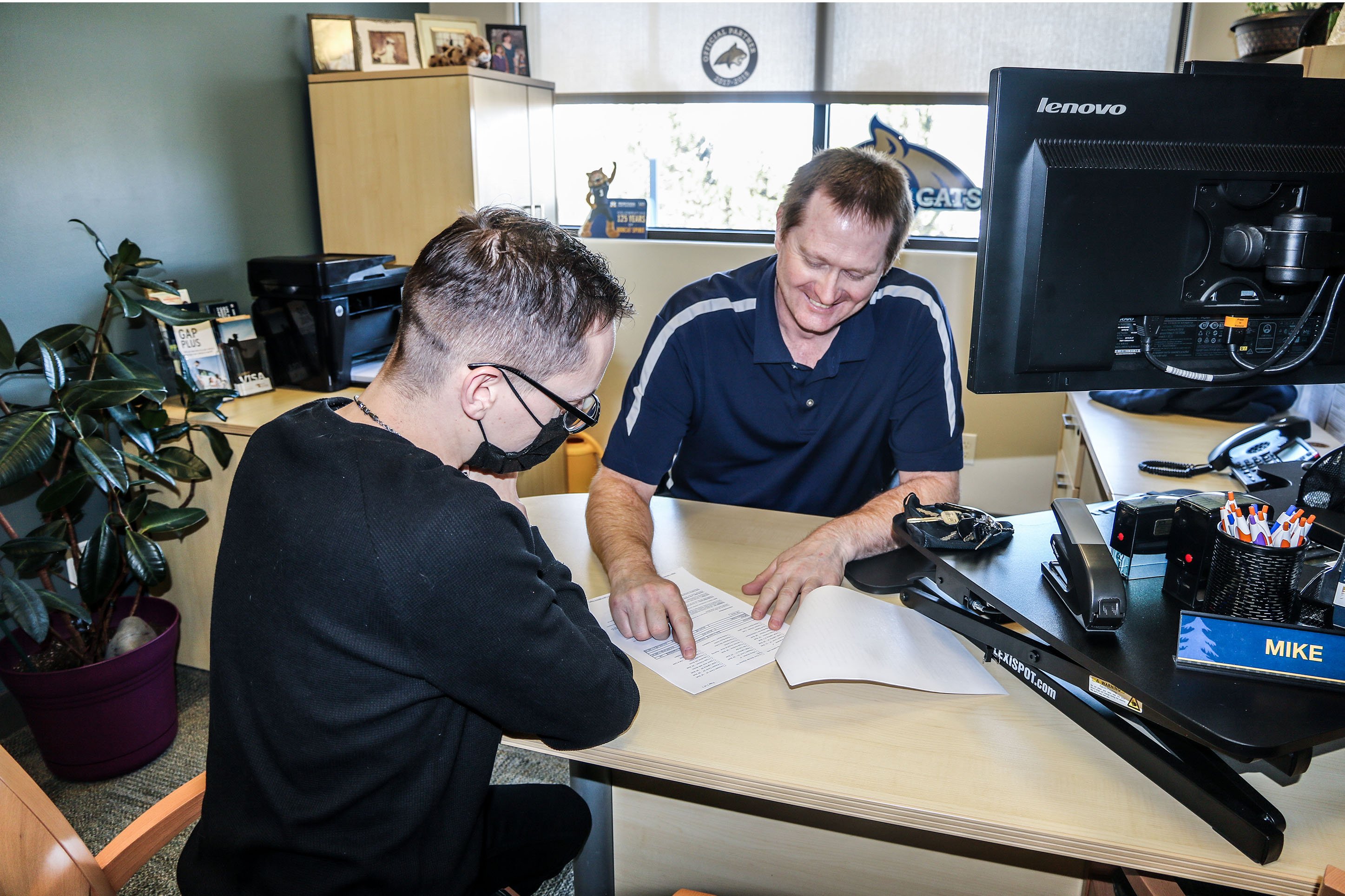 Two men reviewing a business contract. 