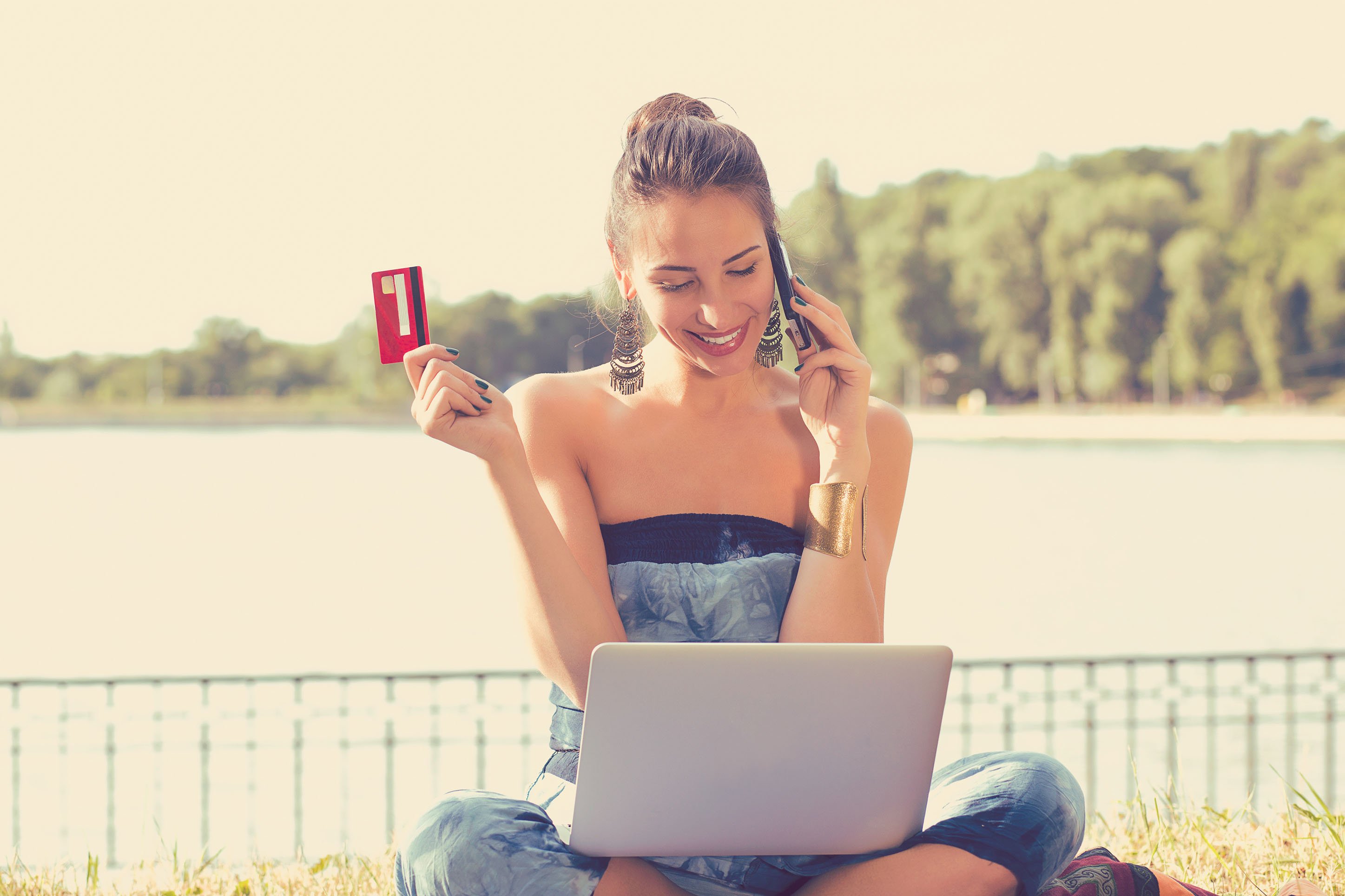 Woman on the phone using her travel rewards. 