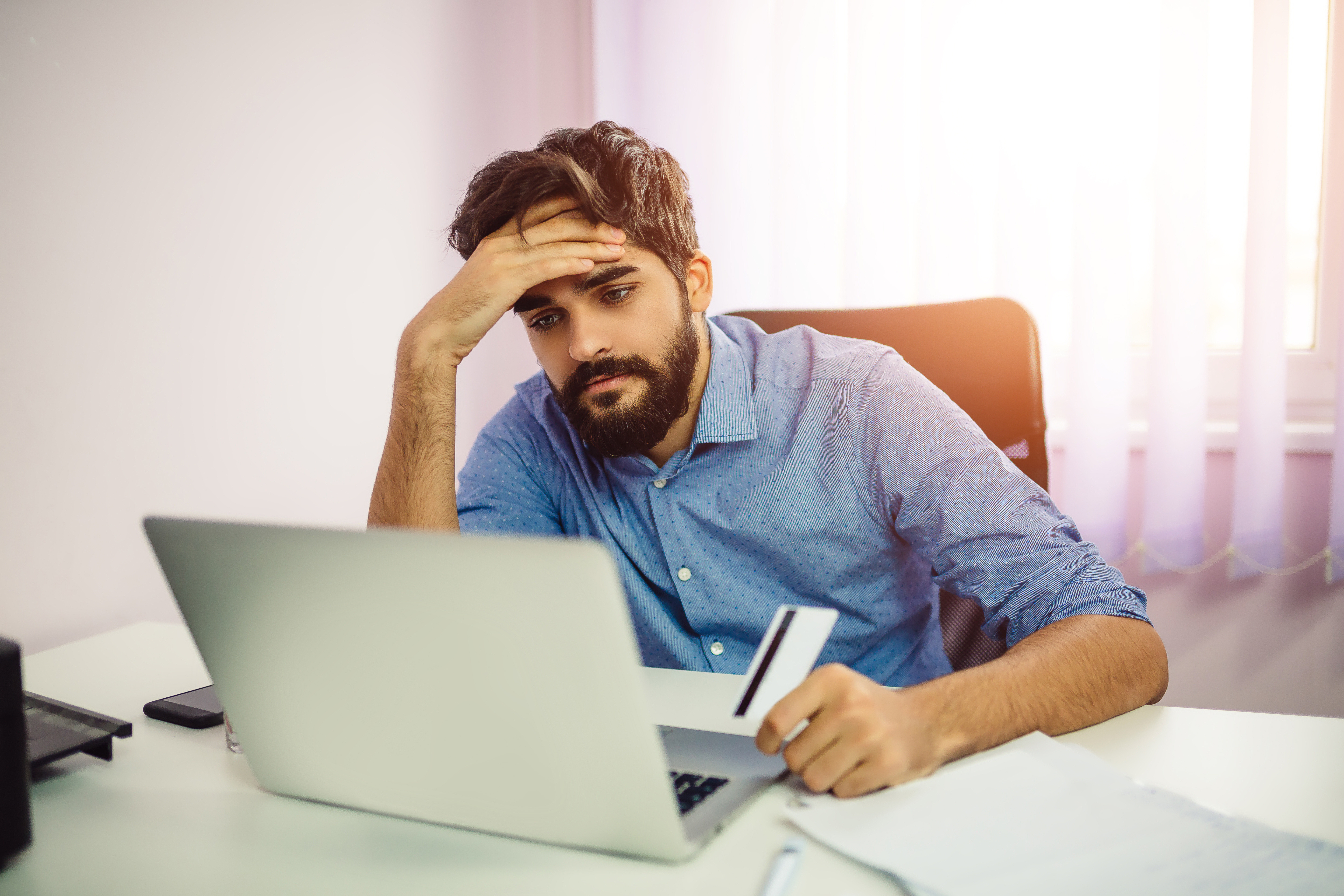 Man struggling on credit card debit