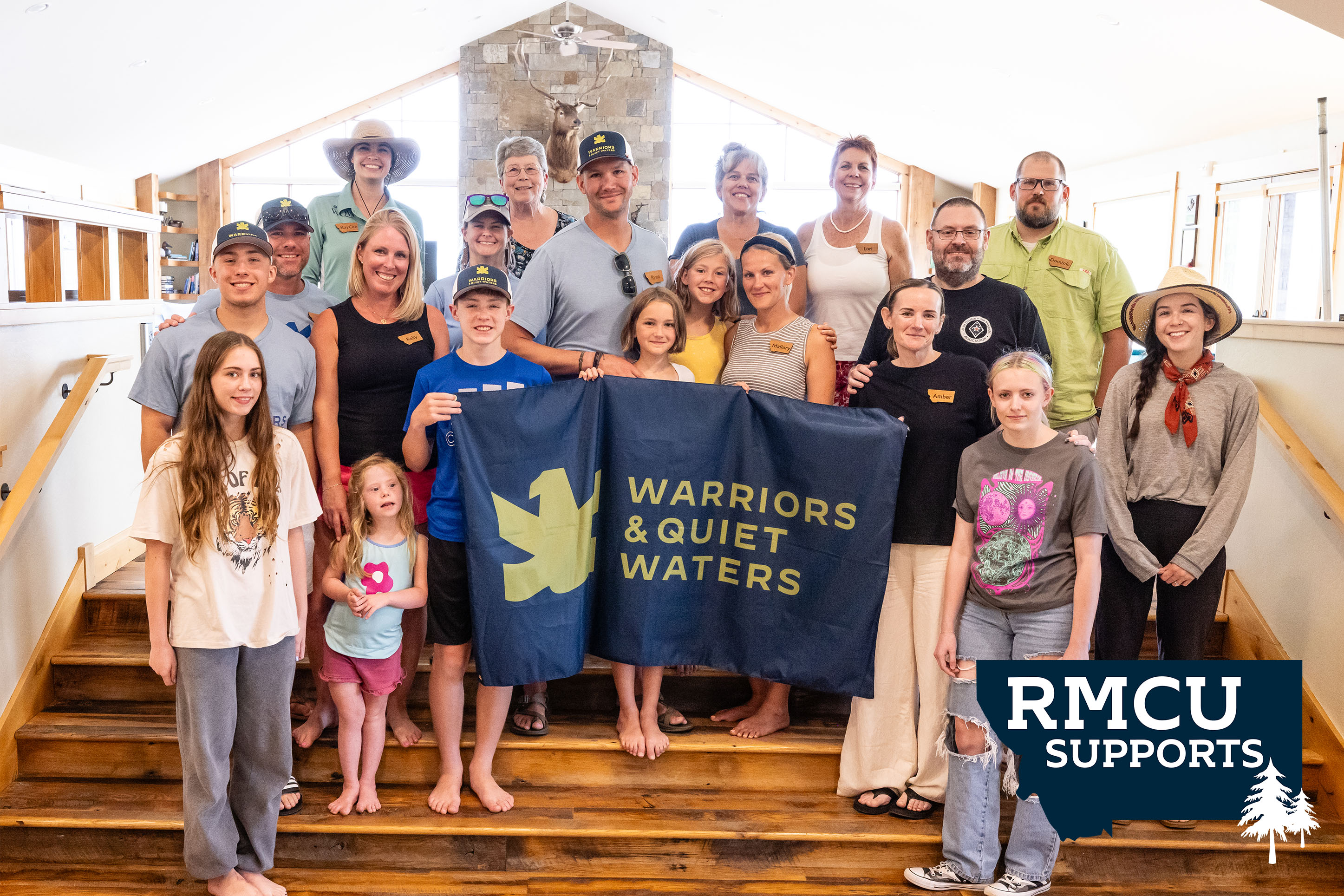 Photo of Veterans & their families holding a WQW banner