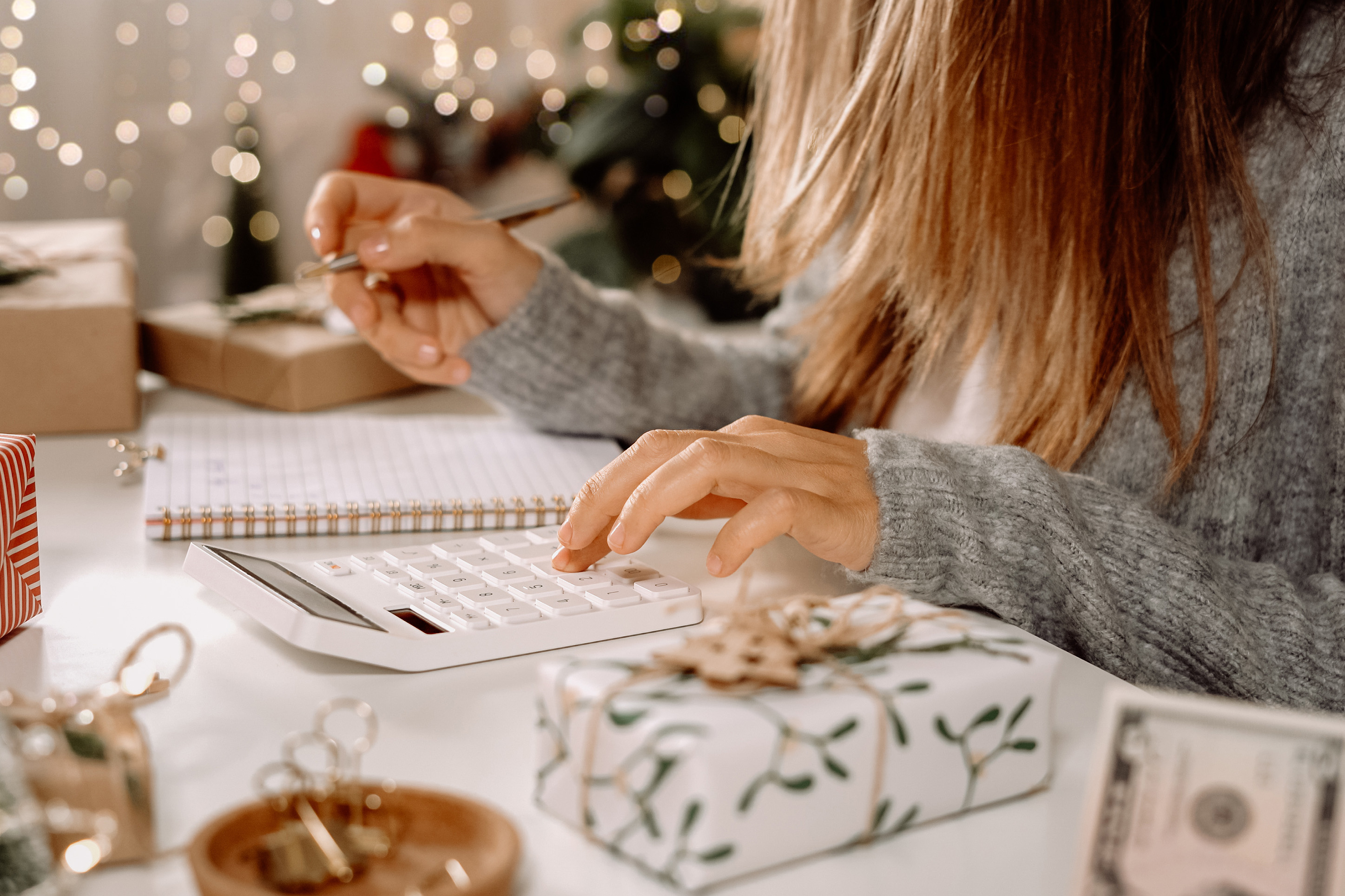 Woman budgeting for holiday gifts. 