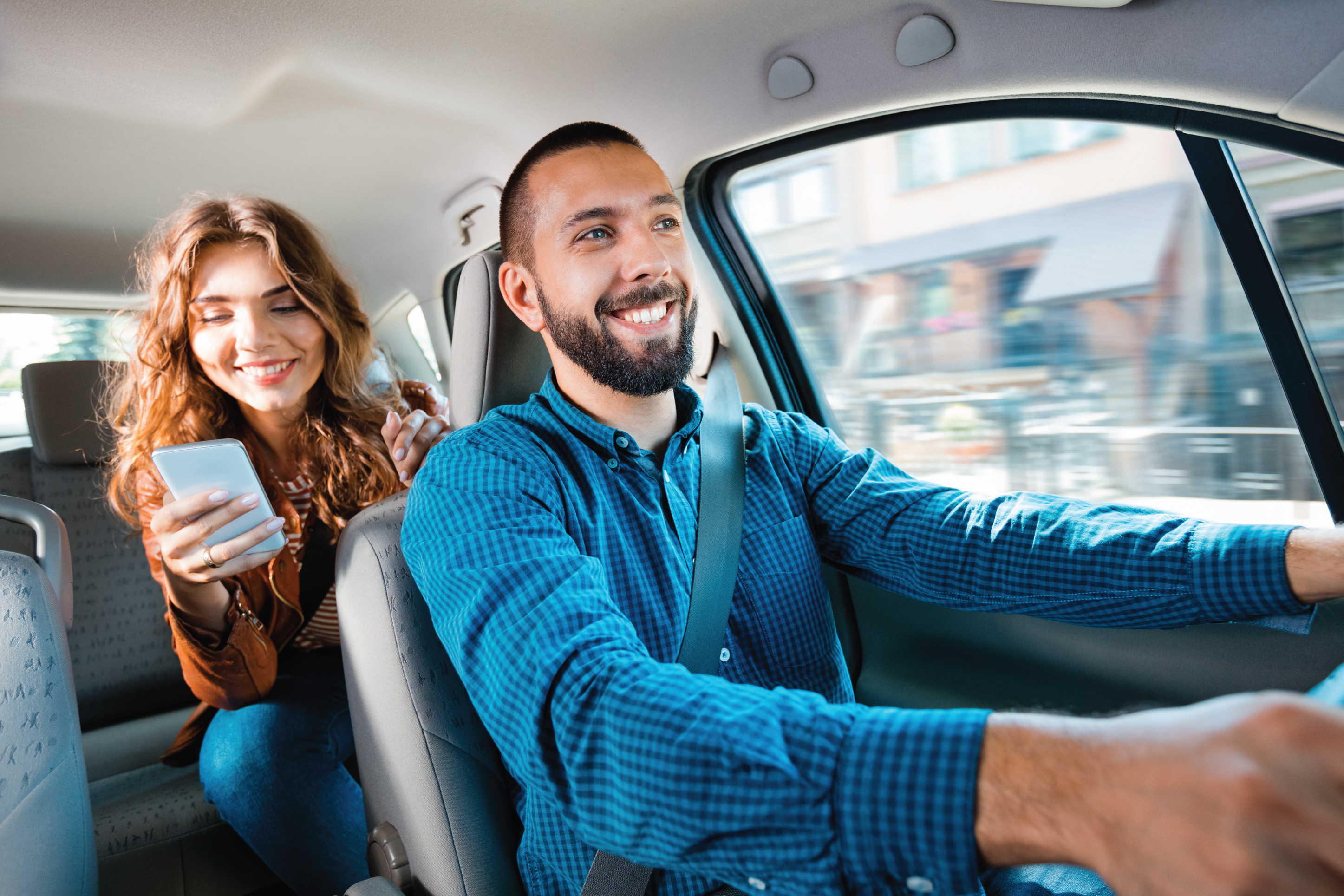 Woman riding in the back of an uber car