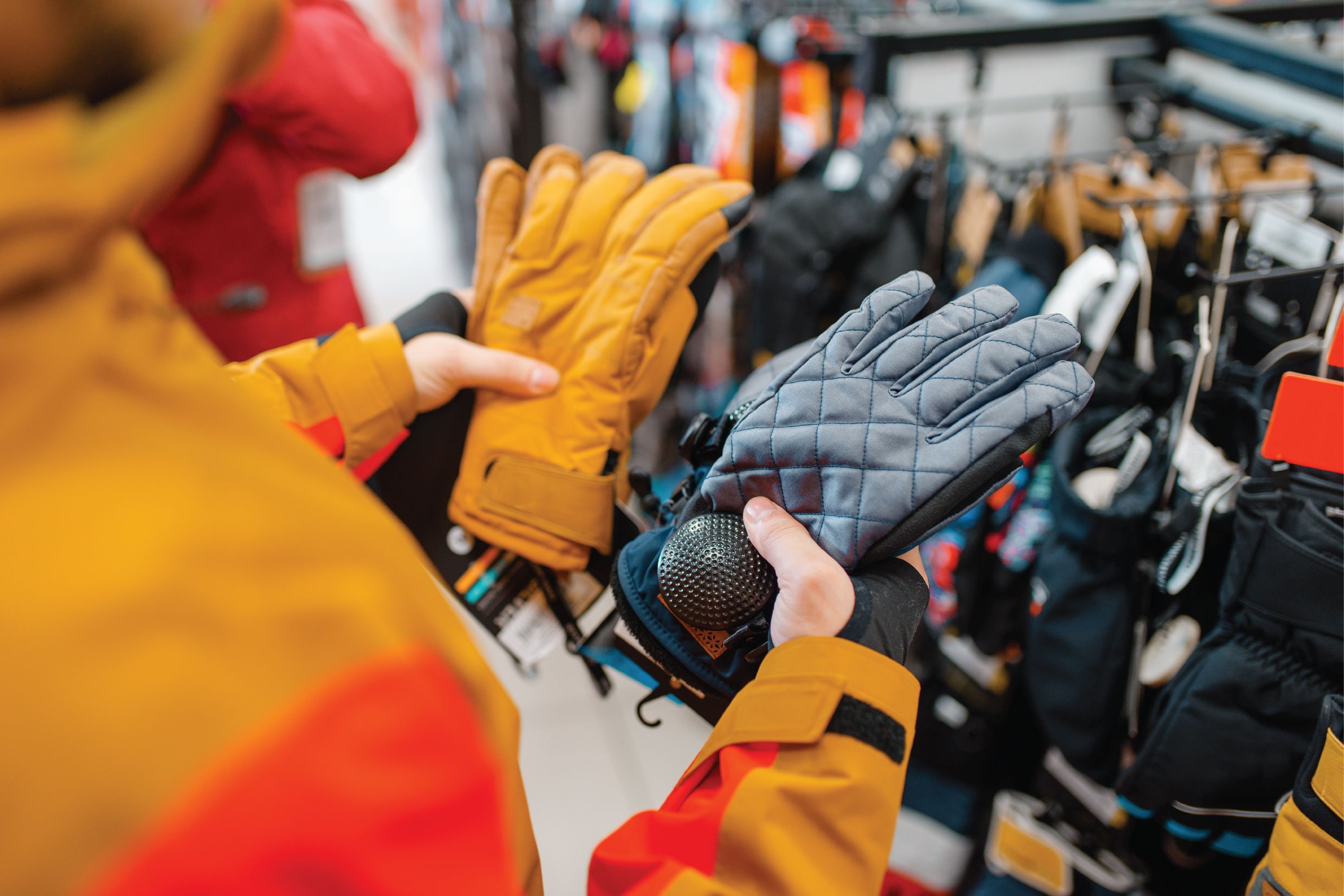 person shopping for snow gloves
