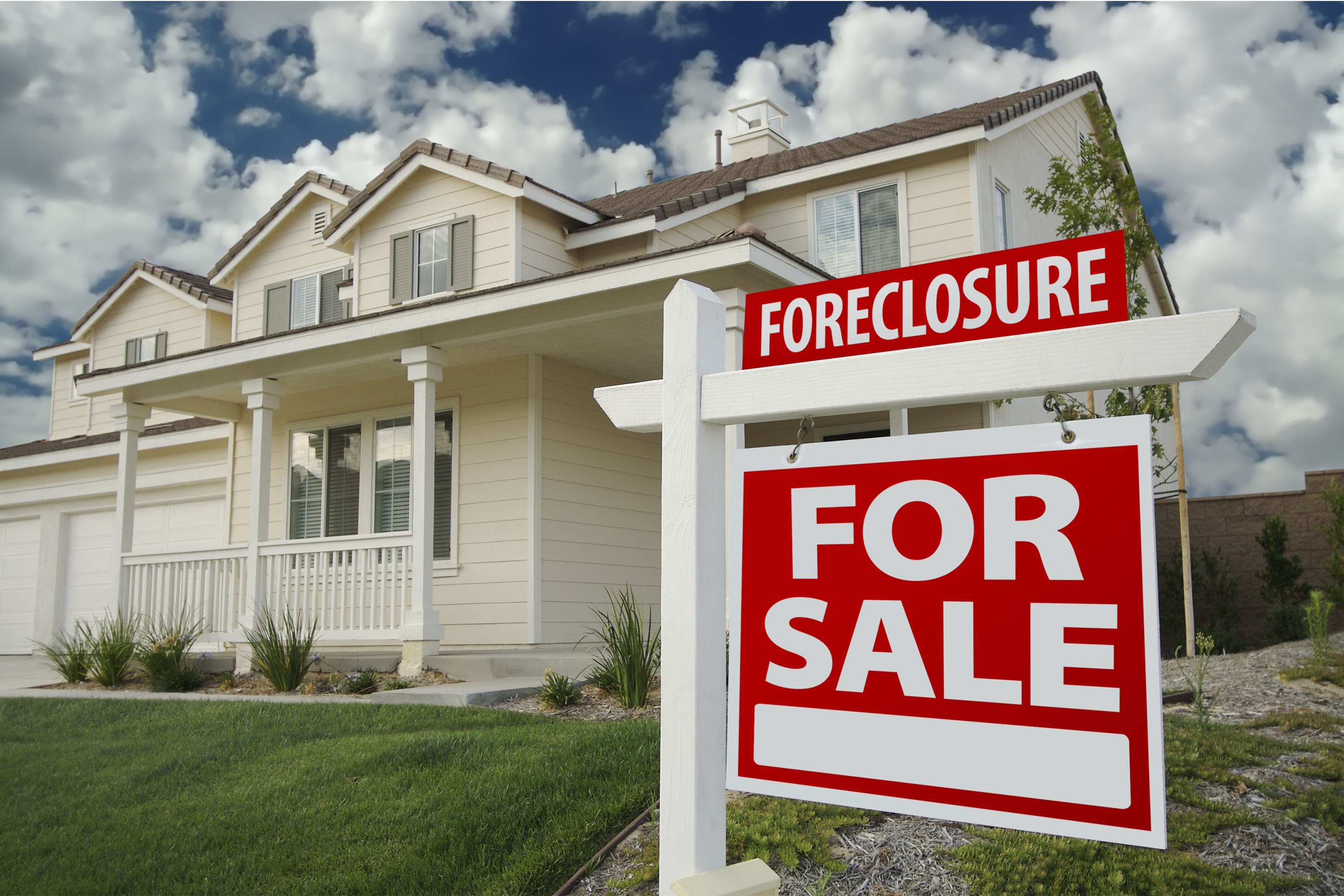 Home with a foreclosure sign. 